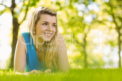 Fit blonde lying on the grass