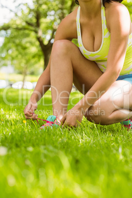Athletic  woman tying her shoelace