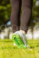 Woman in sports shoes jogging at park