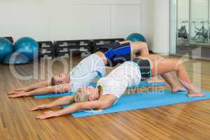 Couple doing pilate exercises at fitness studio