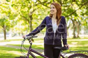 Pretty redhead with her bike