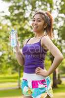 Healthy woman holding water bottle in park