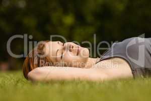 Pretty redhead lying with her eyes closed