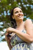 Portrait of a smiling brunette holding her braid