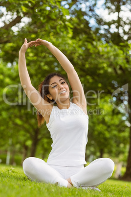 Healthy woman stretching hands in park