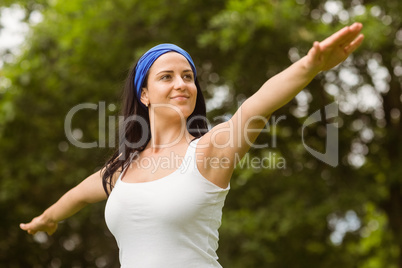 Portrait of a smiling brunette doing yoga