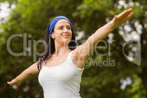 Portrait of a smiling brunette doing yoga