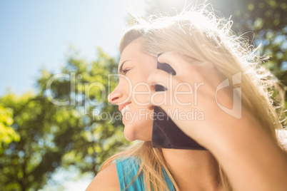 Fit blonde talking on her smartphone