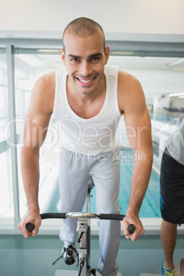 Man working out on exercise bike at gym