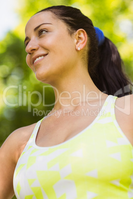 Happy fit brunette posing in the park