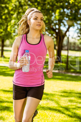 Fit blonde jogging in the park