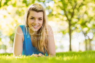 Fit blonde lying on the grass