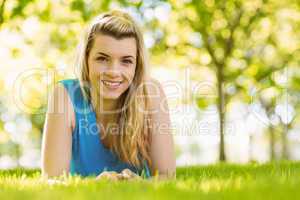 Fit blonde lying on the grass