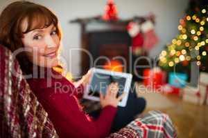 Beauty redhead using tablet at christmas