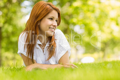 Portrait of a pretty redhead smiling and lying