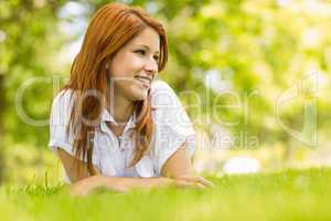 Portrait of a pretty redhead smiling and lying