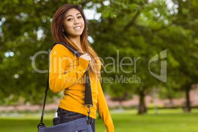 Female college student with bag in park