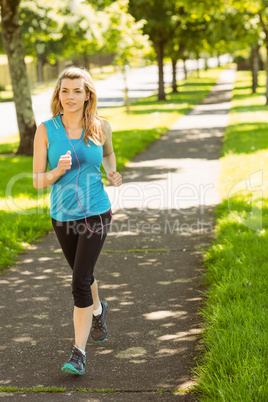 Fit blonde jogging in the park