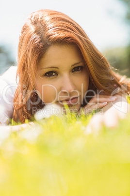 Portrait of a pretty redhead calm and lying