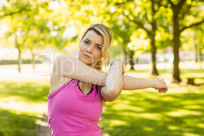 Fit blonde stretching in the park