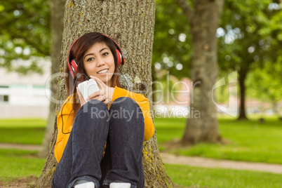 Relaxed woman enjoying music in park