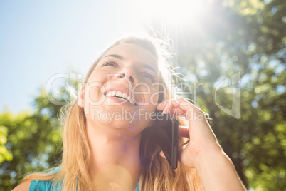 Fit blonde talking on her smartphone