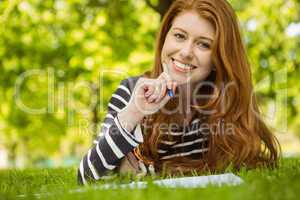 Female student doing homework in park