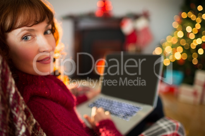 Peaceful redhead using laptop at christmas