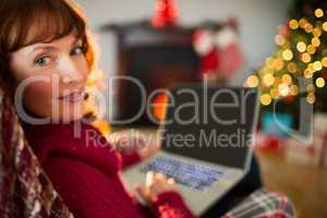 Peaceful redhead using laptop at christmas