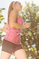 Fit blonde jogging in the park