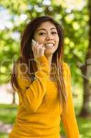 Woman using mobile phone in park