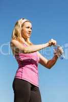 Fit blonde opening her water bottle