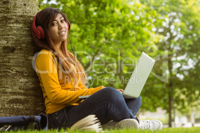 Relaxed woman using laptop in park