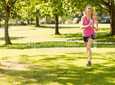 Fit blonde jogging in the park