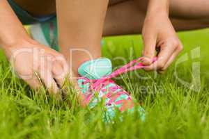 Fit woman tying her shoelace