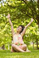 Portrait of relaxed young woman sitting at park