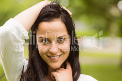 Happy brunette posing and looking at camera