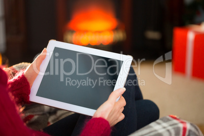 Woman in jumper using tablet at christmas