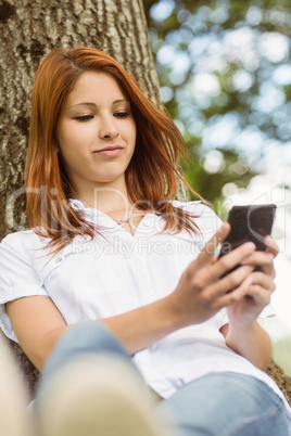 Pretty redhead text messaging on her phone