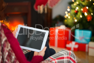 Redhead using tablet computer at christmas