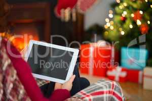 Redhead using tablet computer at christmas