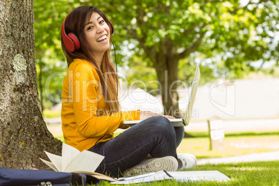 Relaxed woman enjoying music in park