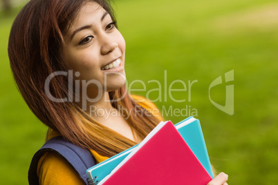 Female college student with books in park