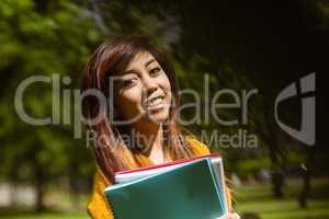 Female college student with books in park