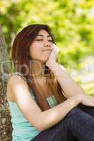 Beautiful woman with eyes closed in park