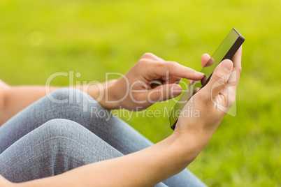 Mid section of a pretty redhead texting Mid section of a pretty redhead texting