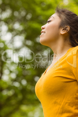 Beautiful woman with eyes closed in park