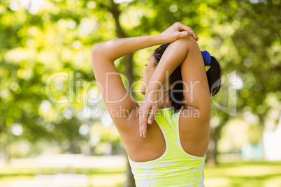 Rear view of a fit brunette stretching