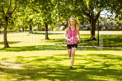 Fit blonde jogging in the park