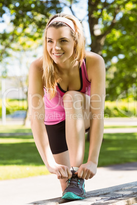 Fit blonde tying her shoelace